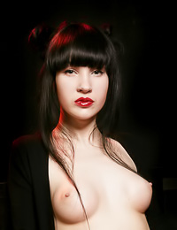 Gothic Asian babe Ditta A looks stunningly sexy with redlipstick and black stockings on.