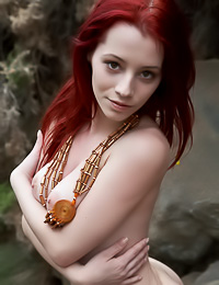 Smoking hot redhead babe Ariel A poses nude outdoors and shows her beautiful big jugs.